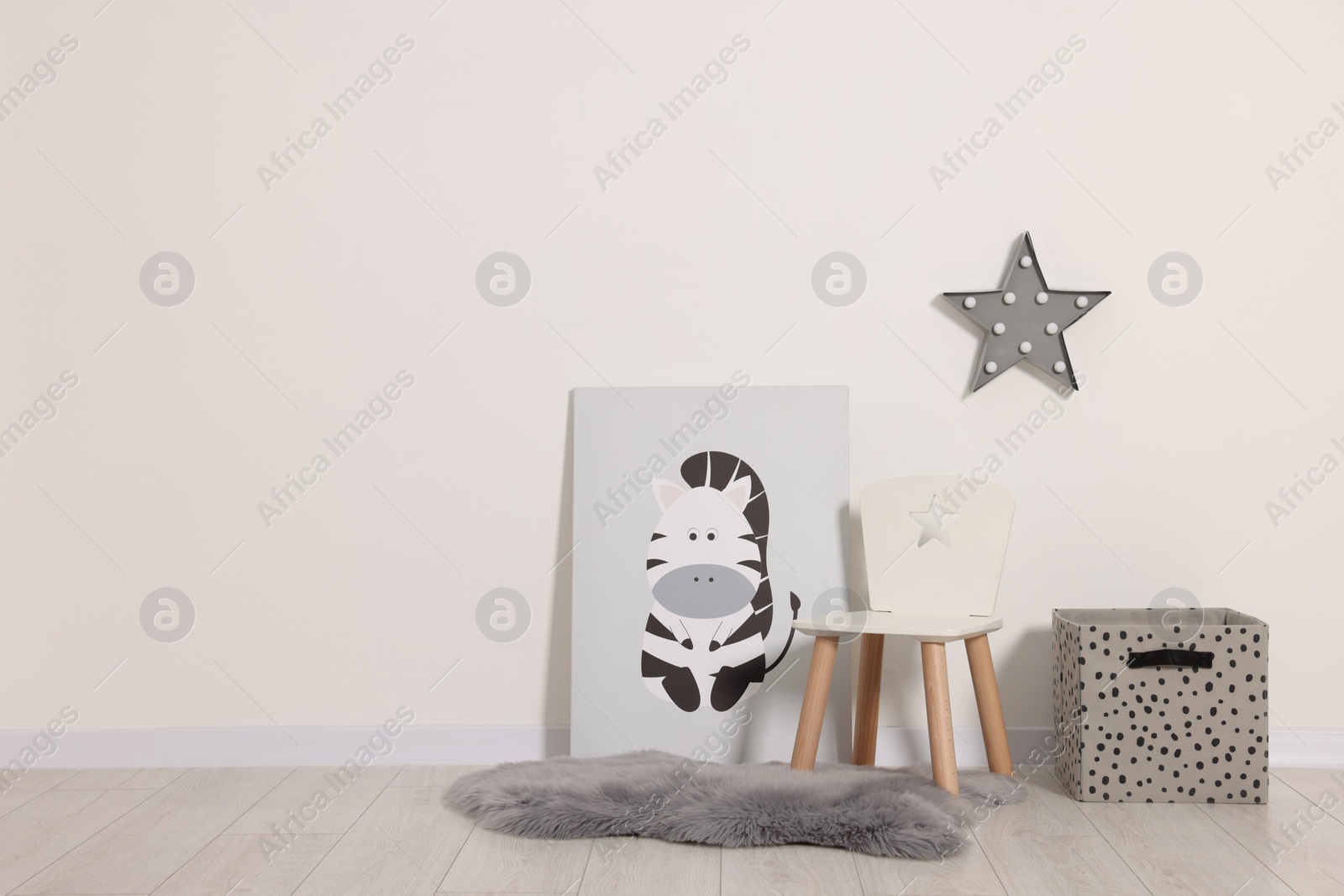 Photo of Beautiful children's room with light wall and furniture, space for text. Interior design