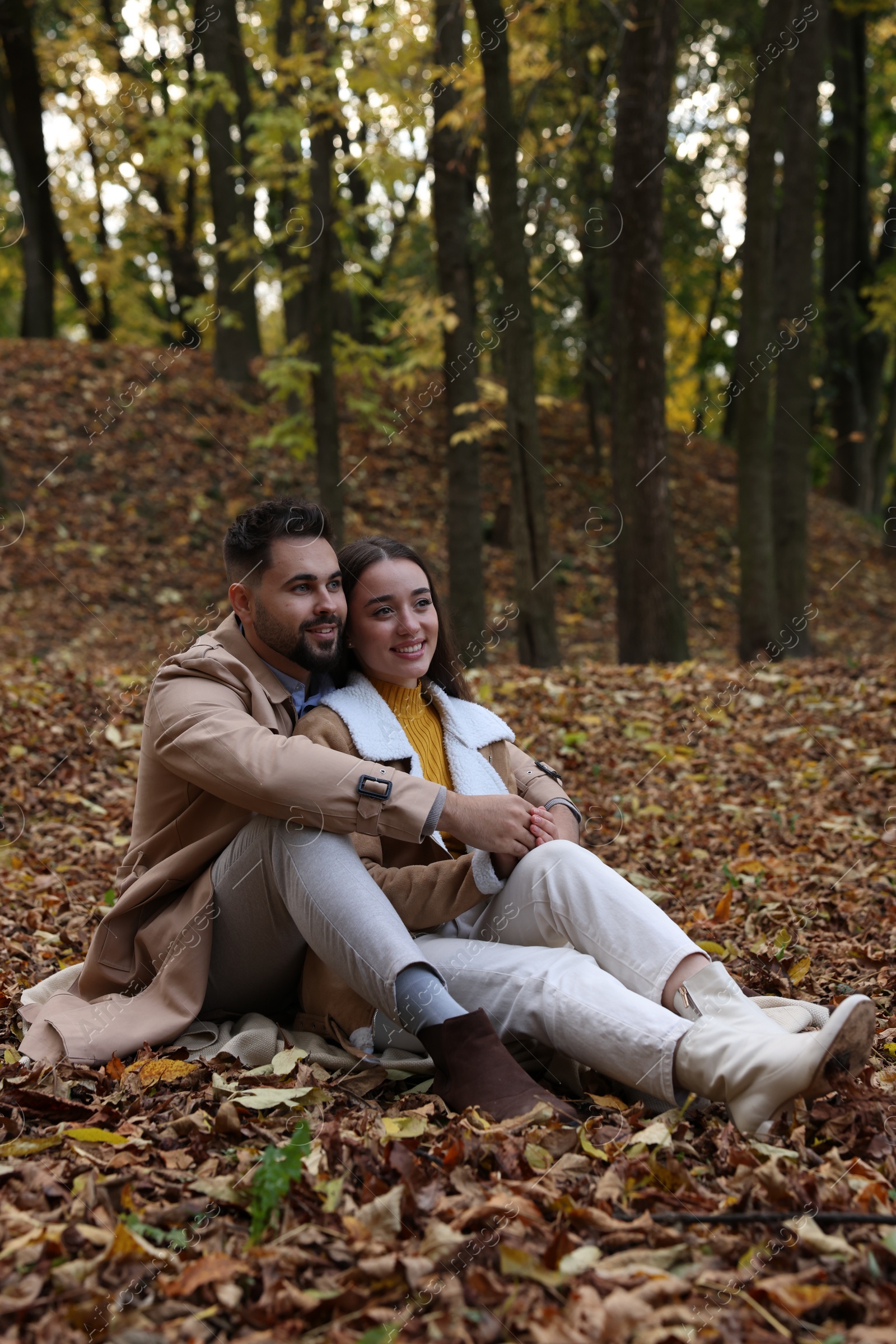 Photo of Happy young couple spending time together in autumn park