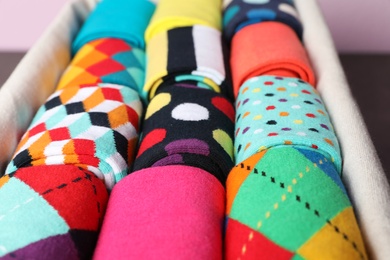 Photo of Box with different colorful socks, closeup