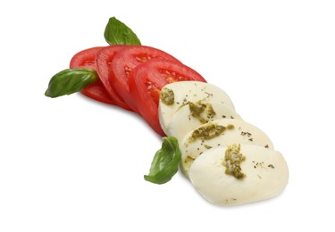 Tasty salad Caprese with mozzarella, tomatoes, basil and pesto sauce isolated on white