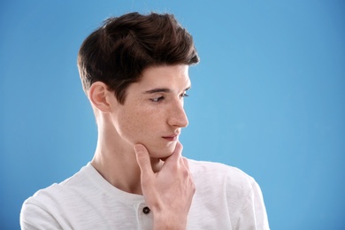 Photo of Portrait of young man with beautiful hair on color background