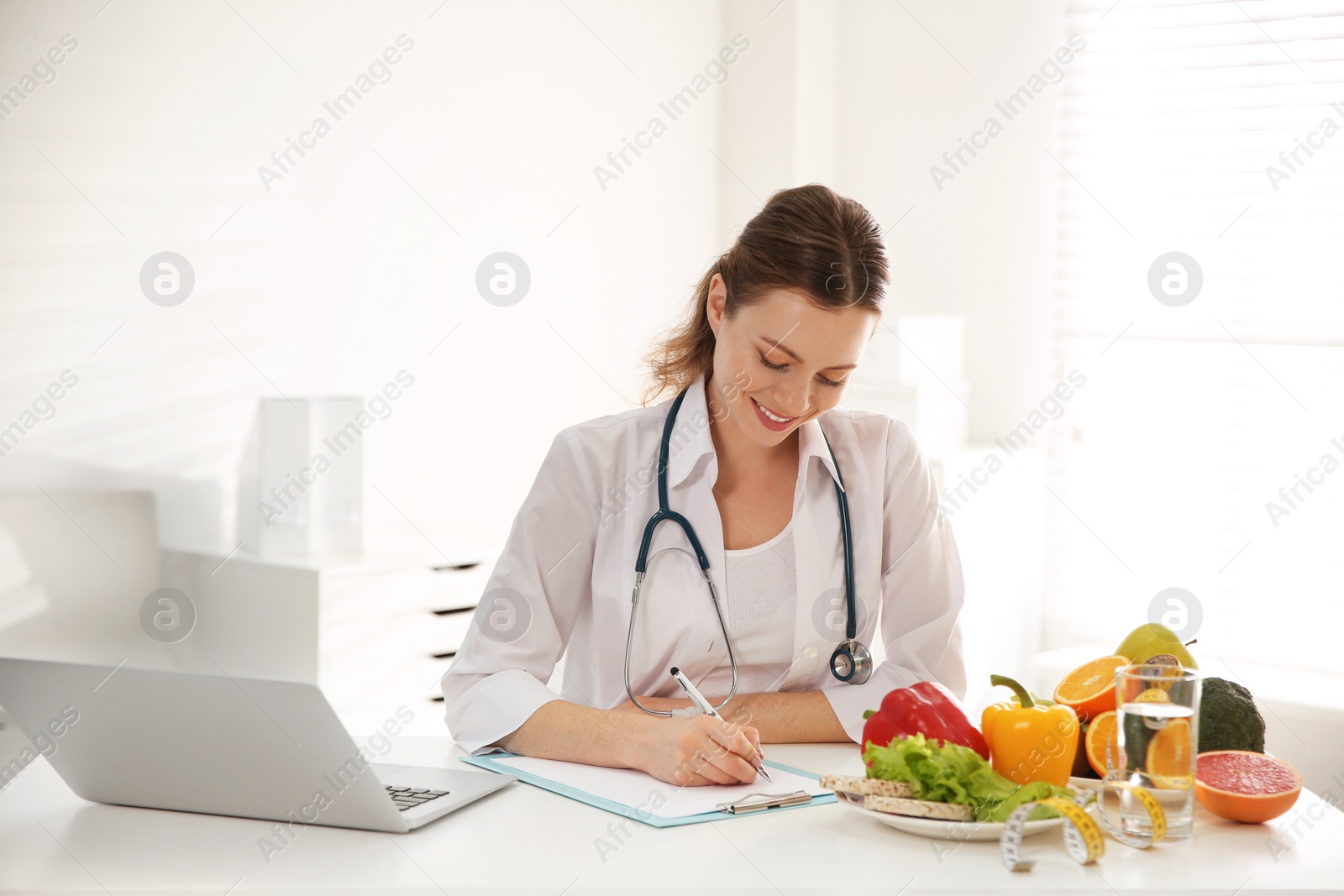 Photo of Female nutritionist working at desk in office