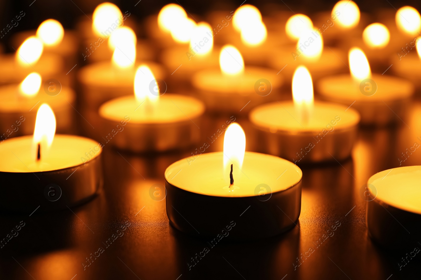 Photo of Many burning candles on table. Memory day