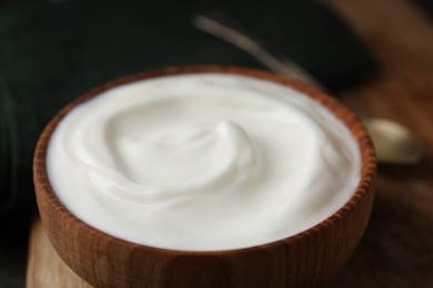 Photo of Delicious natural yogurt in bowl on table, closeup