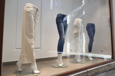Photo of Shop display with mannequins in stylish pants