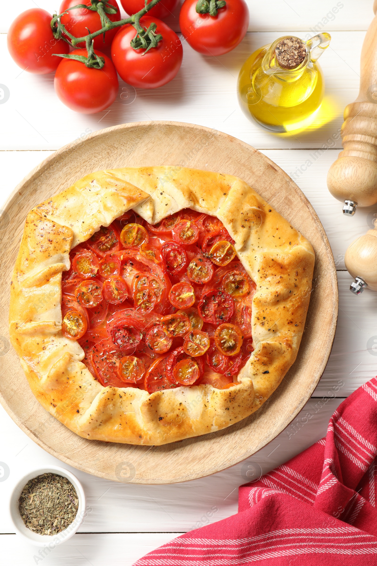 Photo of Flat lay composition with tasty tomato galette (Caprese galette) on white wooden table