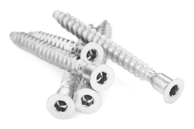 Photo of Metal countersunk screws on white. Hardware tool