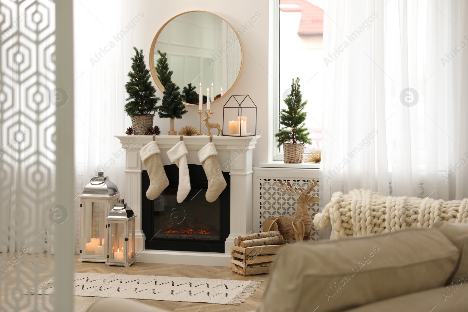 Photo of Fireplace in room with Christmas decorations. Interior design