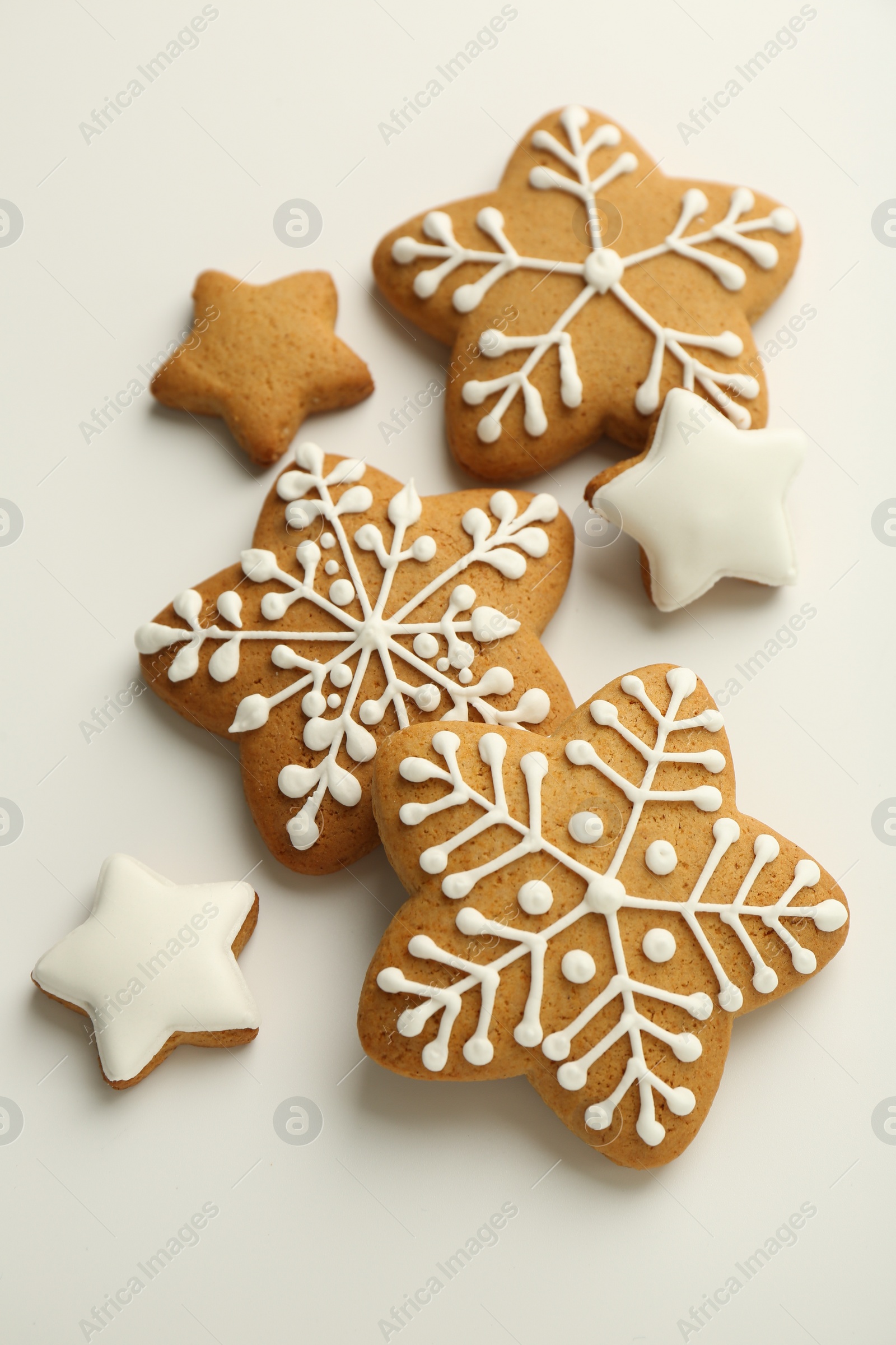 Photo of Tasty Christmas cookies with icing on white background