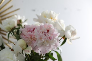 Bouquet of beautiful peony flowers on light background, closeup