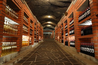 Beregove, Ukraine - June 23, 2023: Many bottles of alcohol drinks on shelves in cellar