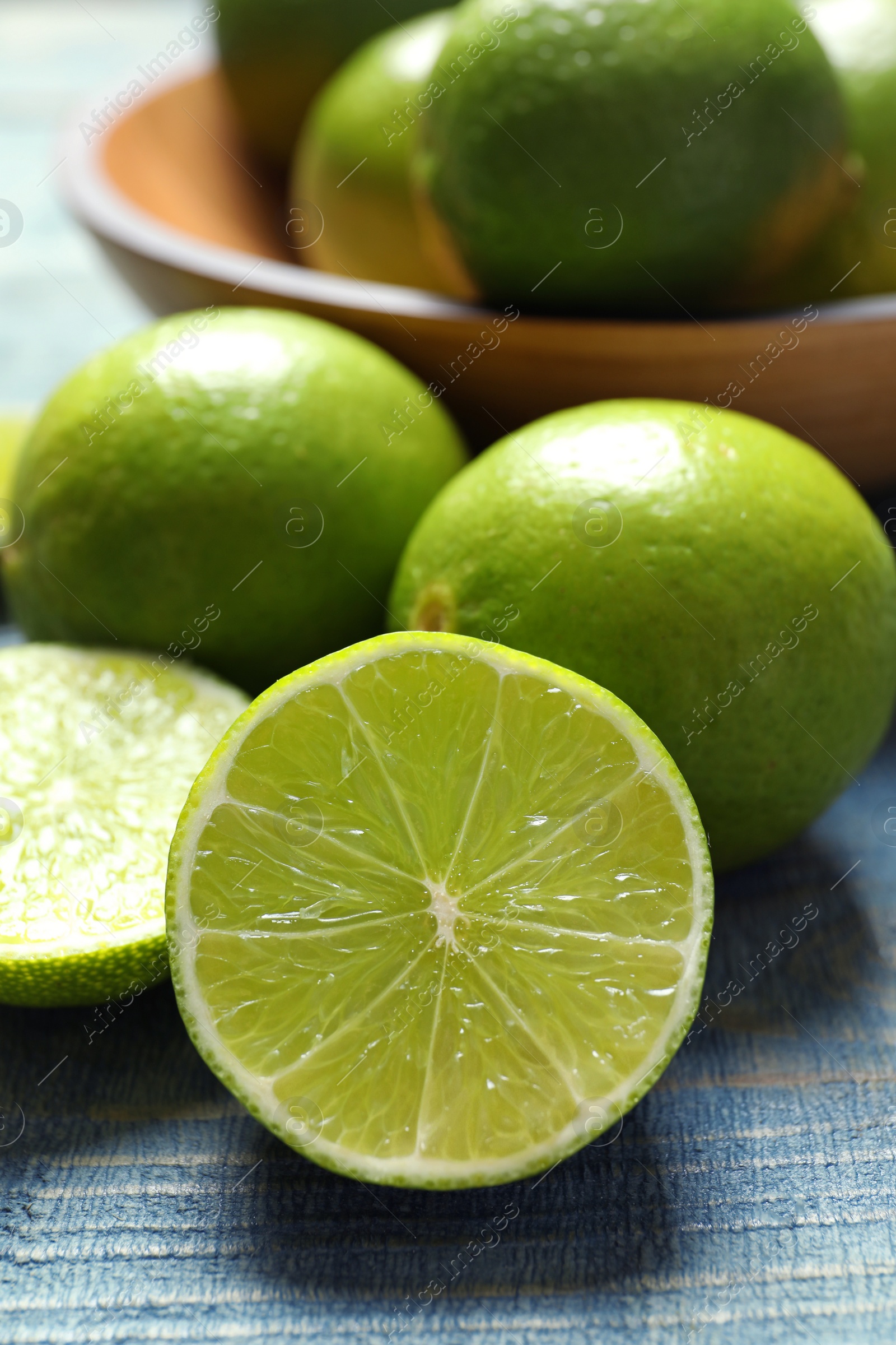 Photo of Fresh ripe limes on wooden table. Citrus fruit