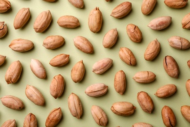 Photo of Composition with ripe pecan nuts on color background, flat lay