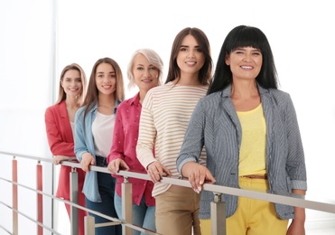 Photo of Group of ladies near handrails indoors. Women power concept
