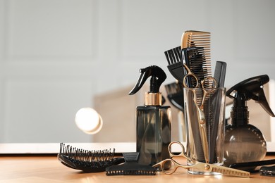 Photo of Set of hairdresser tools on table in salon, space for text