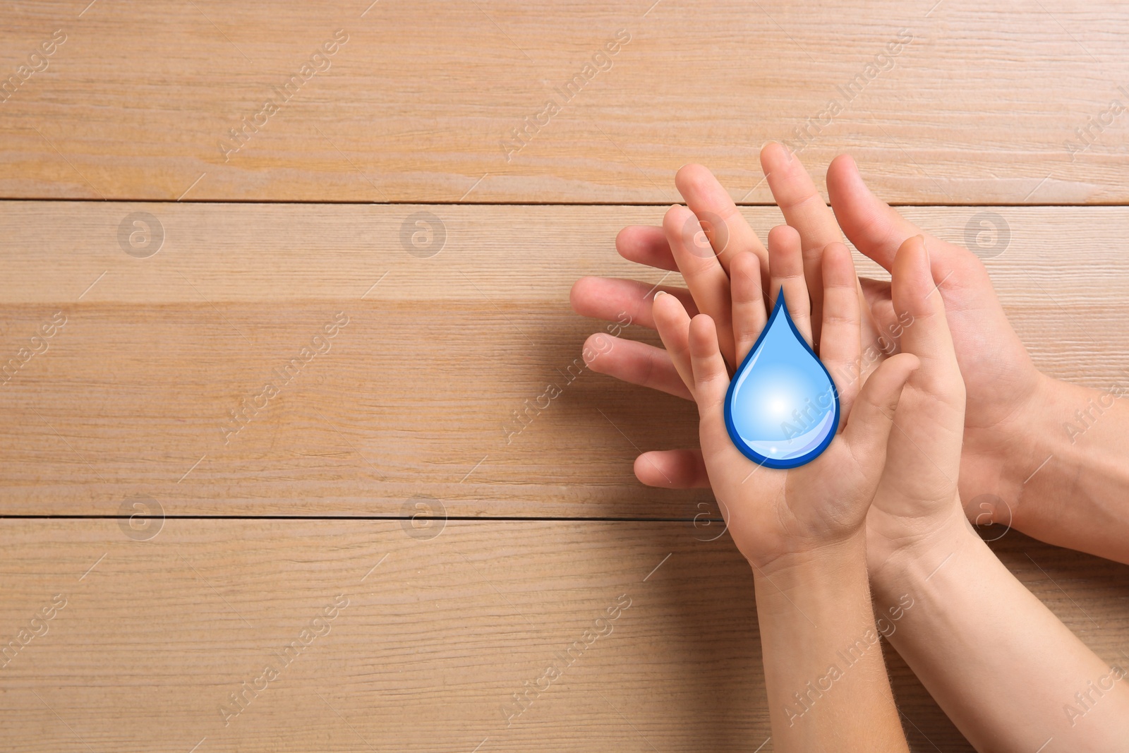 Image of Family holding paper water drop on wooden background, top view. Space for text