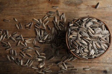 Organic sunflower seeds on wooden table, flat lay