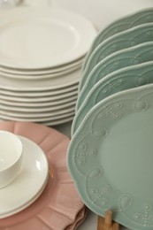 Photo of Many different clean plates on table in kitchen