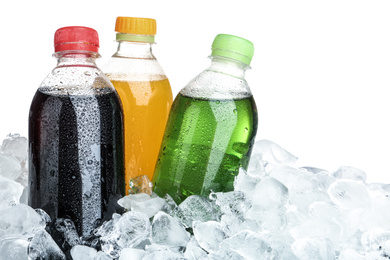 Photo of Ice cubes and different soda drinks on white background