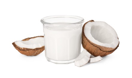 Glass of delicious vegan milk and coconut pieces on white background