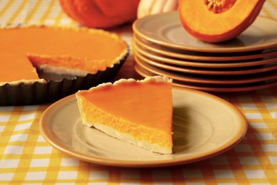 Plate with piece of fresh homemade pumpkin pie on table