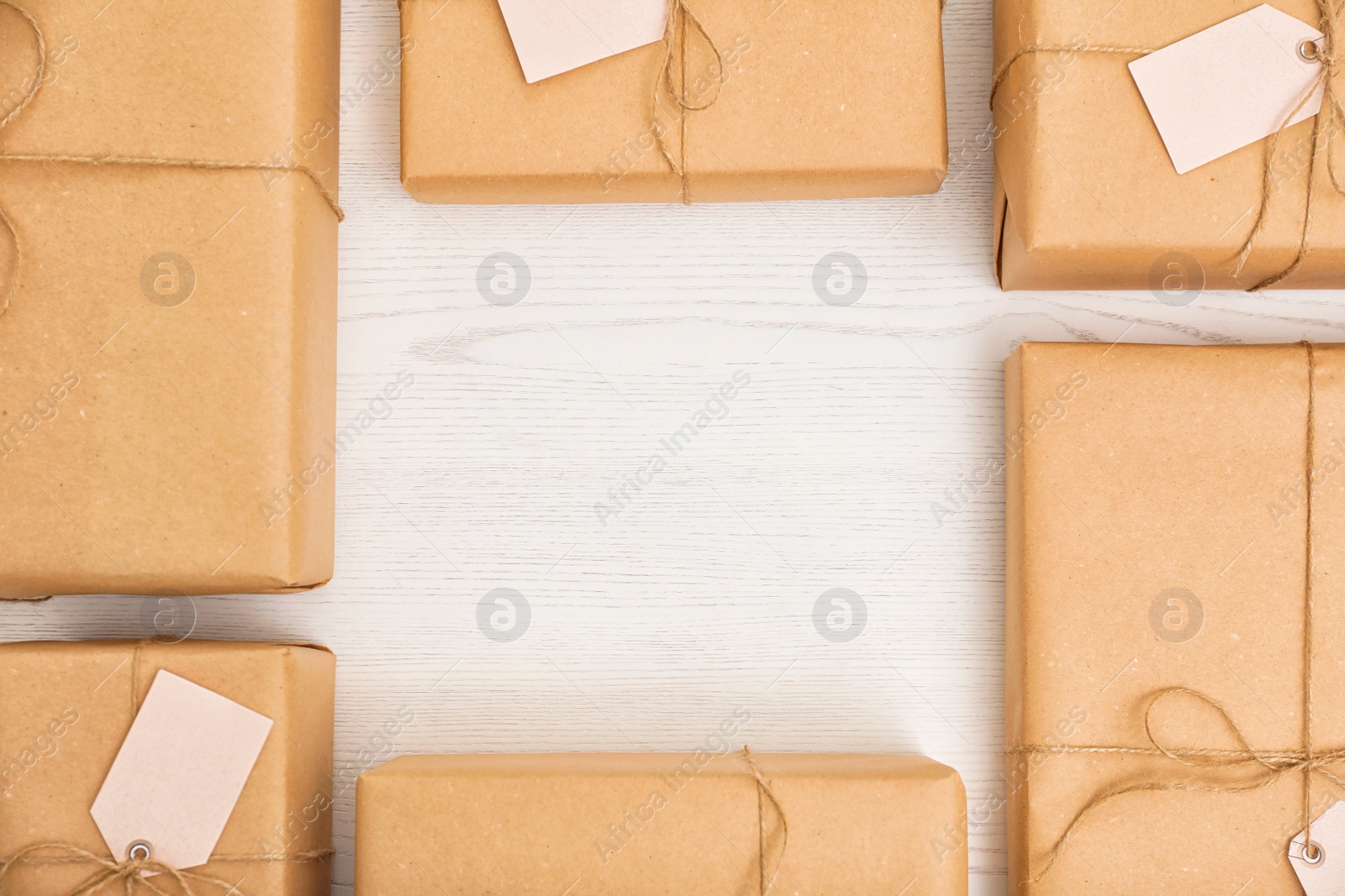 Photo of Flat lay composition with parcels and space for text on wooden background