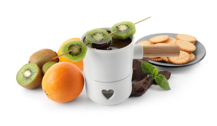 Photo of Fondue pot with chocolate and fruits on white background