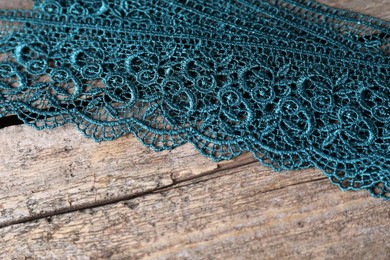 Photo of Beautiful lace on wooden table, above view