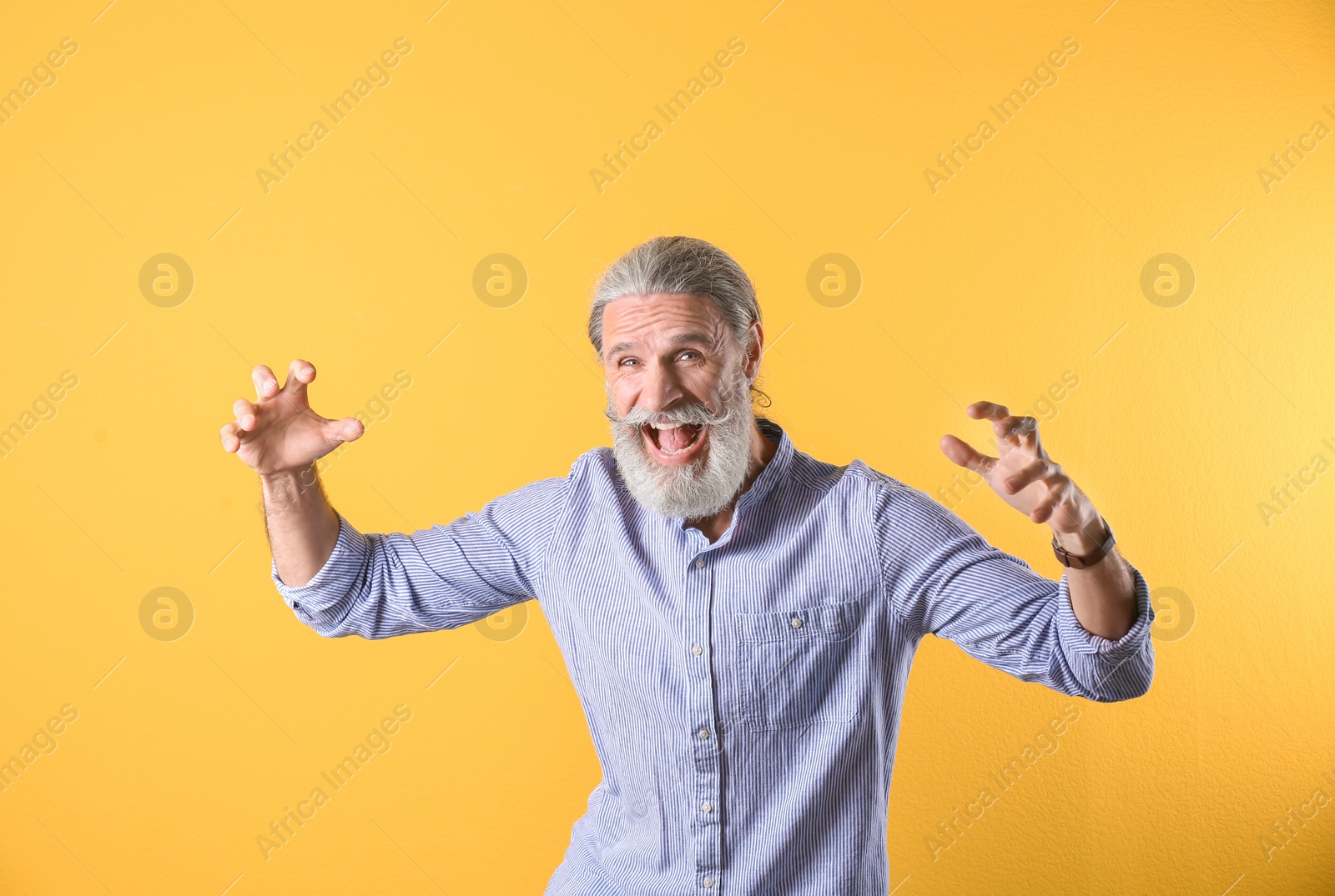 Photo of Portrait of handsome mature man on color background