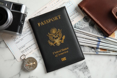 Photo of Flat lay composition with tourist items on marble background. Travel agency