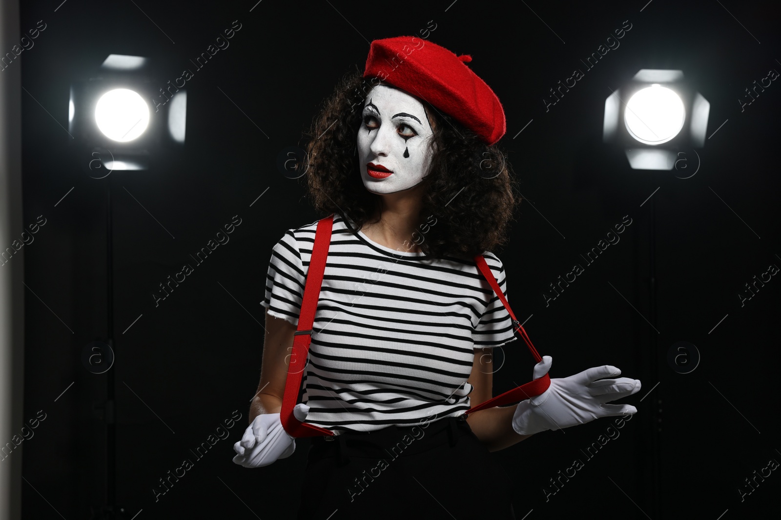 Photo of Young woman in mime costume performing on stage