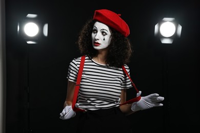 Young woman in mime costume performing on stage