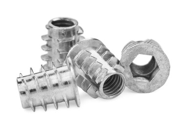 Metal insert nuts isolated on white. Hardware tool