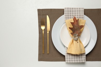 Photo of Autumn table setting and dry leaf, flat lay. Space for text