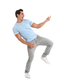 Photo of Handsome young man dancing on white background