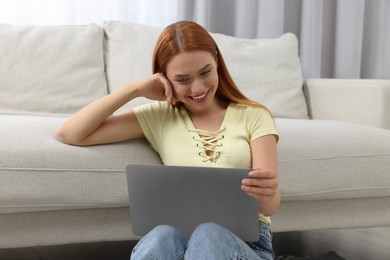 Photo of Woman having video chat via laptop at home