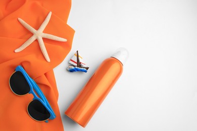 Flat lay composition with bottle of sunscreen on white background. Space for text
