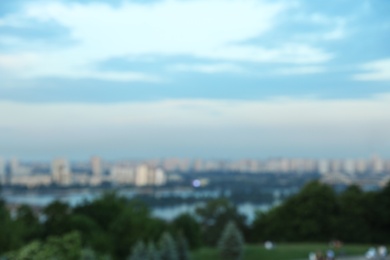 KYIV, UKRAINE - MAY 23, 2019: Beautiful cityscape with green park and Darnitsky railway bridge, bokeh effect