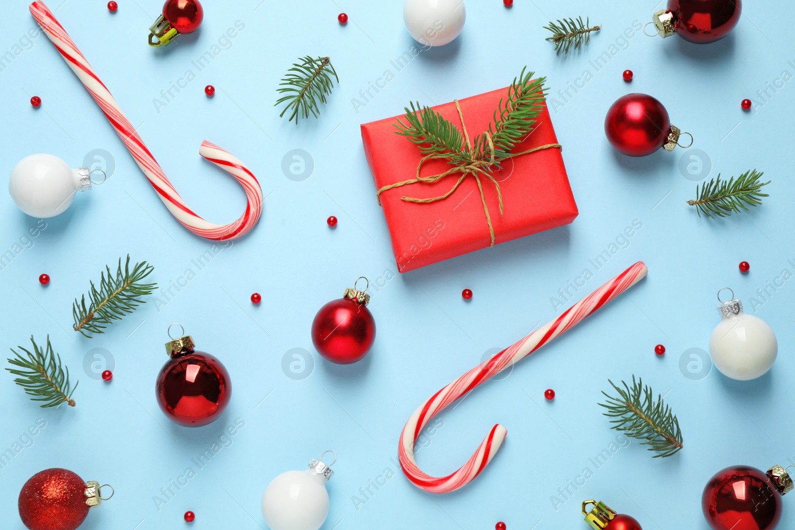 Photo of Flat lay composition with Christmas decorations on light blue background