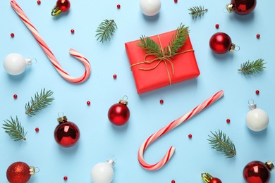 Flat lay composition with Christmas decorations on light blue background