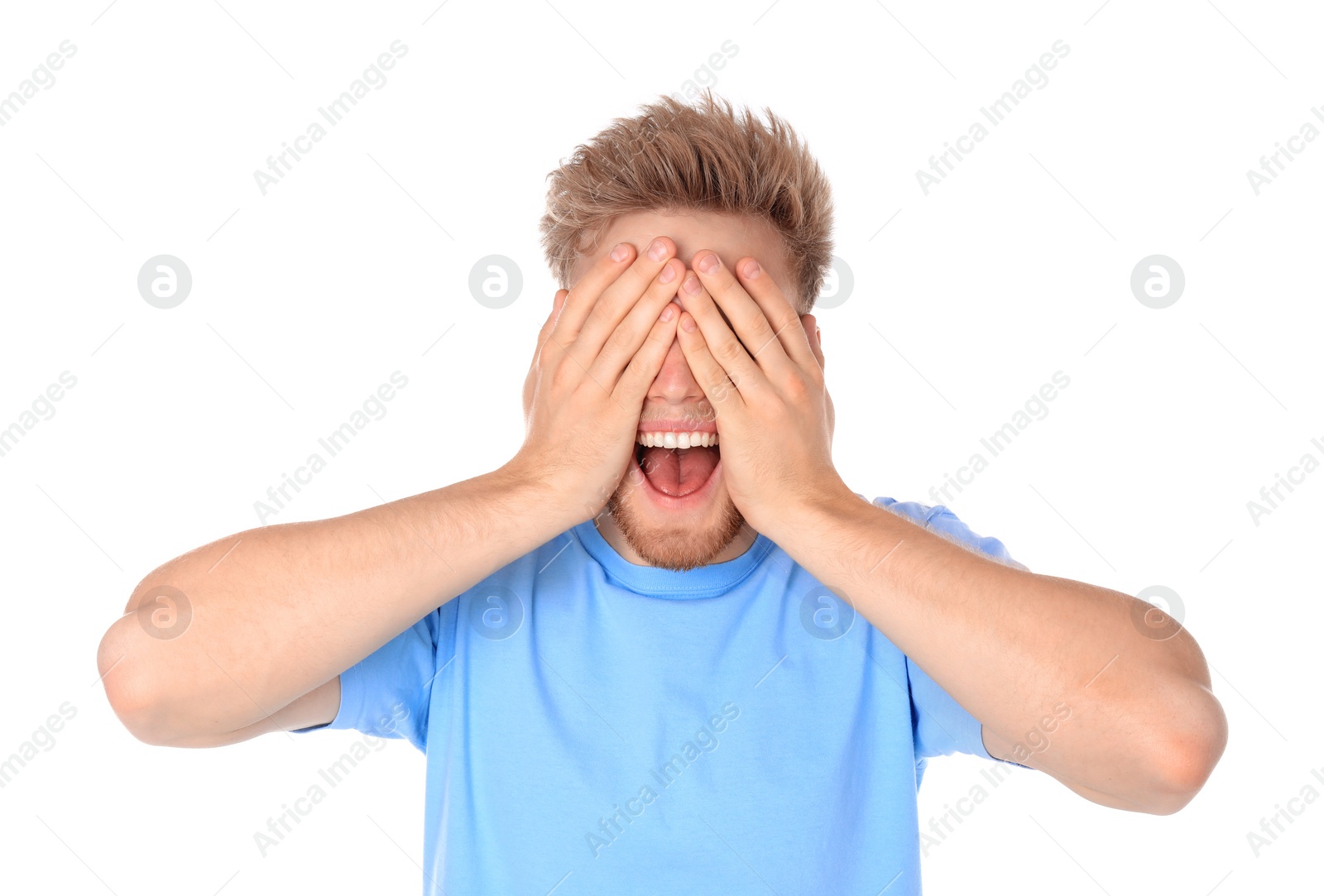 Photo of Young man being blinded and covering eyes with hands on white background