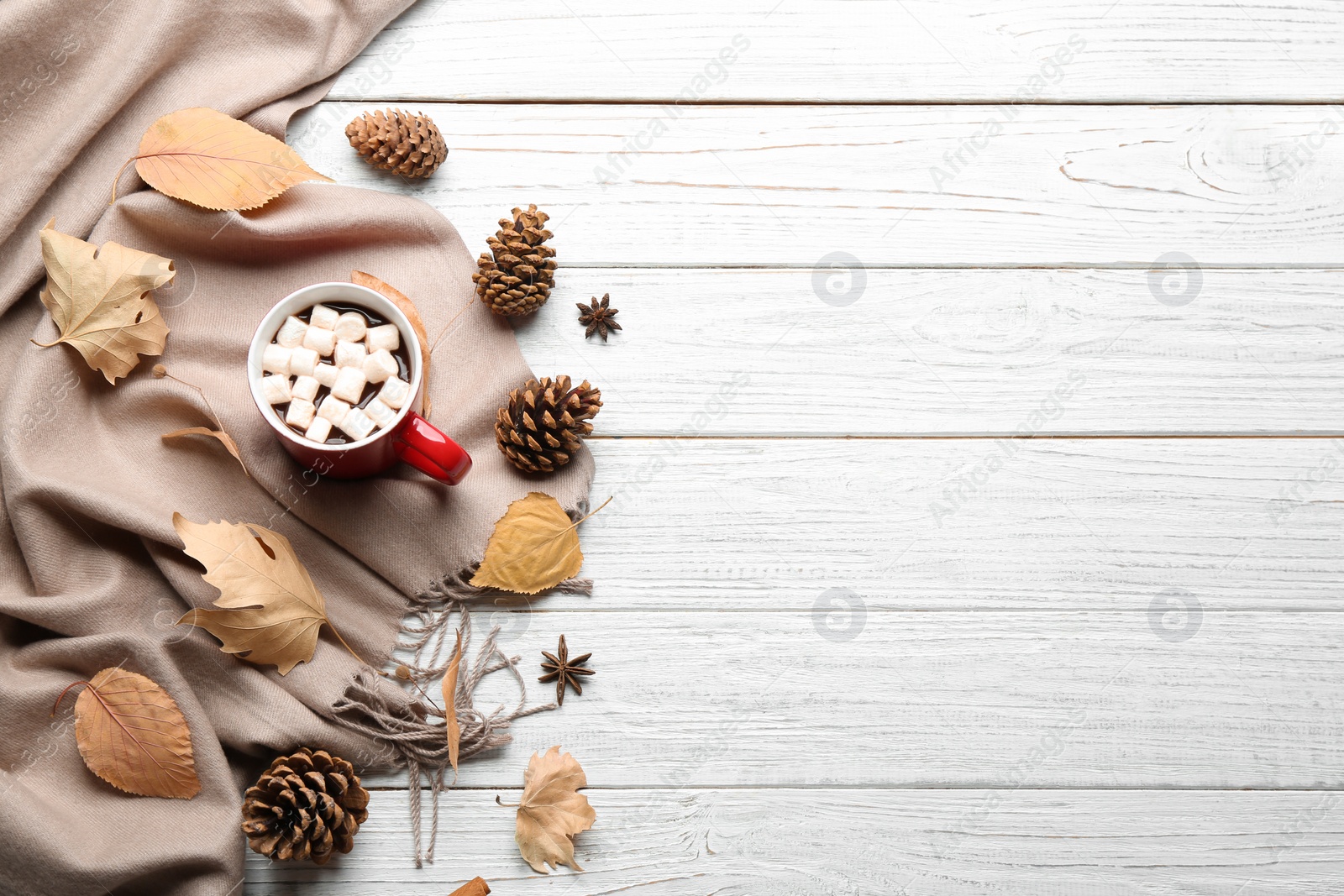 Photo of Flat lay composition with cup of hot drink on white wooden table, space for text. Cozy autumn atmosphere