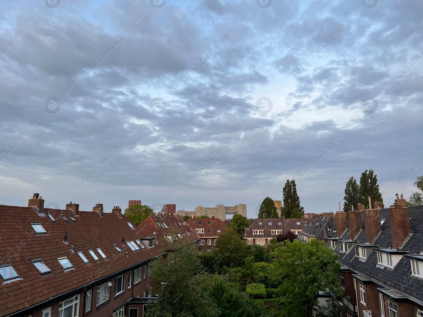 Photo of Picturesque view of city street with beautiful buildings on cloudy day