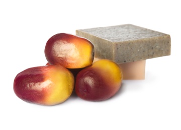 Fresh ripe palm oil fruits and soap bars on white background