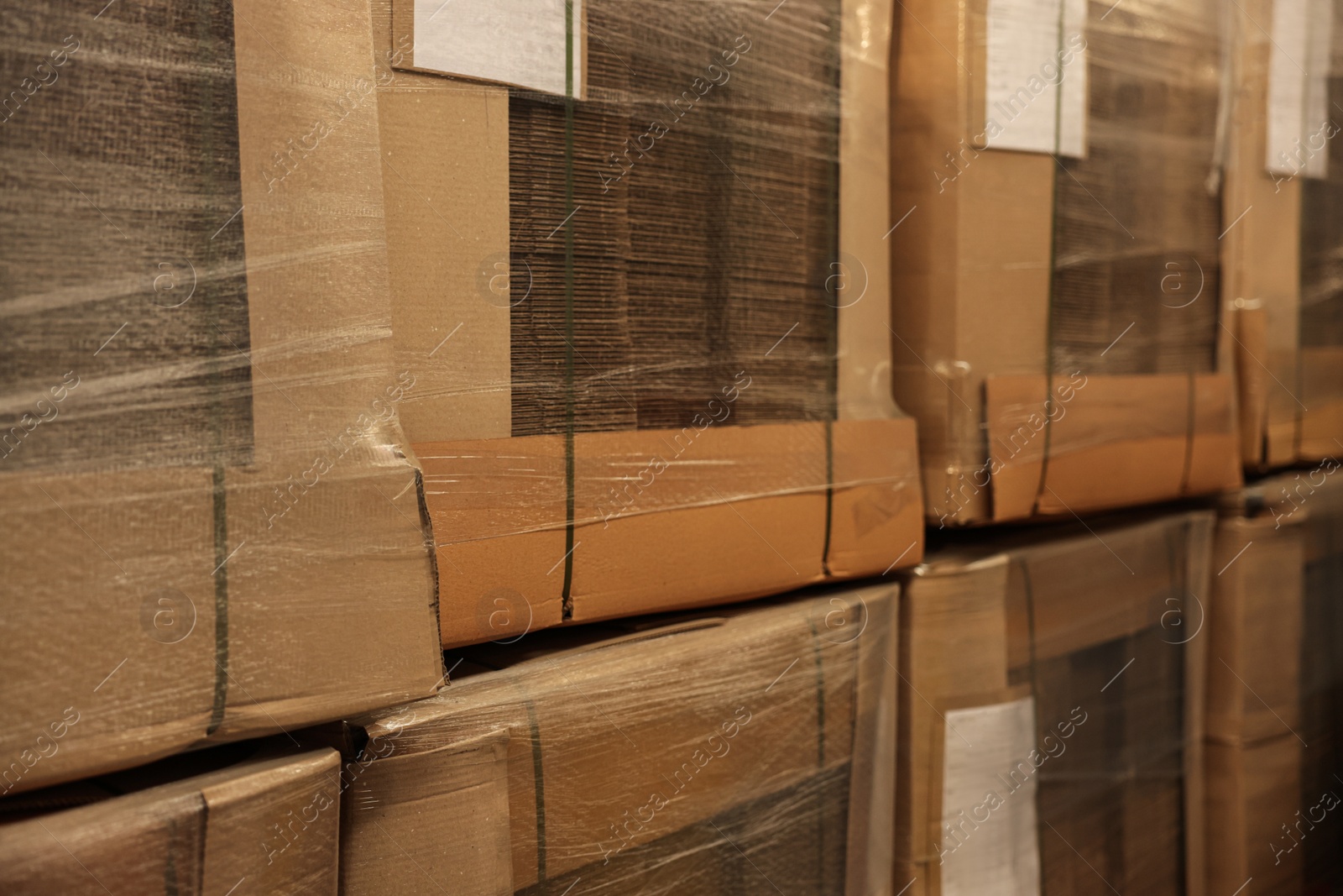 Photo of Closeup view of stacked boxes in warehouse. Wholesaling