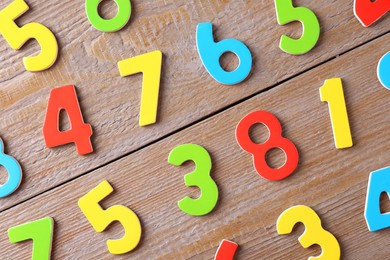 Colorful numbers on wooden table, flat lay