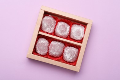 Box of delicious mochi on light background, top view. Traditional Japanese dessert