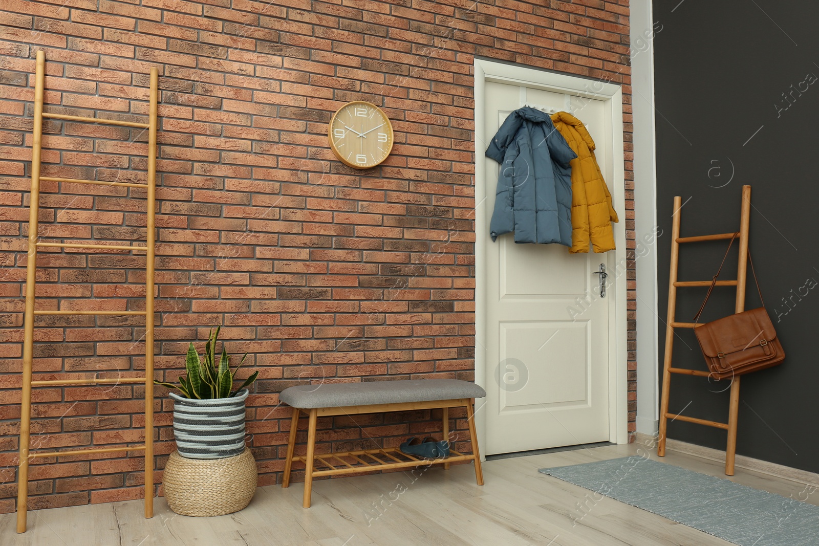 Photo of Hallway interior with stylish furniture, clothes and accessories