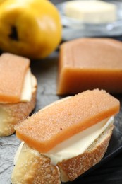 Tasty sandwiches with quince paste on board, closeup