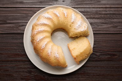 Photo of Delicious freshly baked sponge cake on wooden table, top view